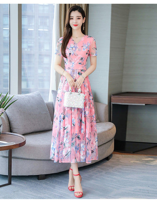 Plus size floral print v-neck midi dress with short sleeves, shown in a vibrant summer floral pattern
