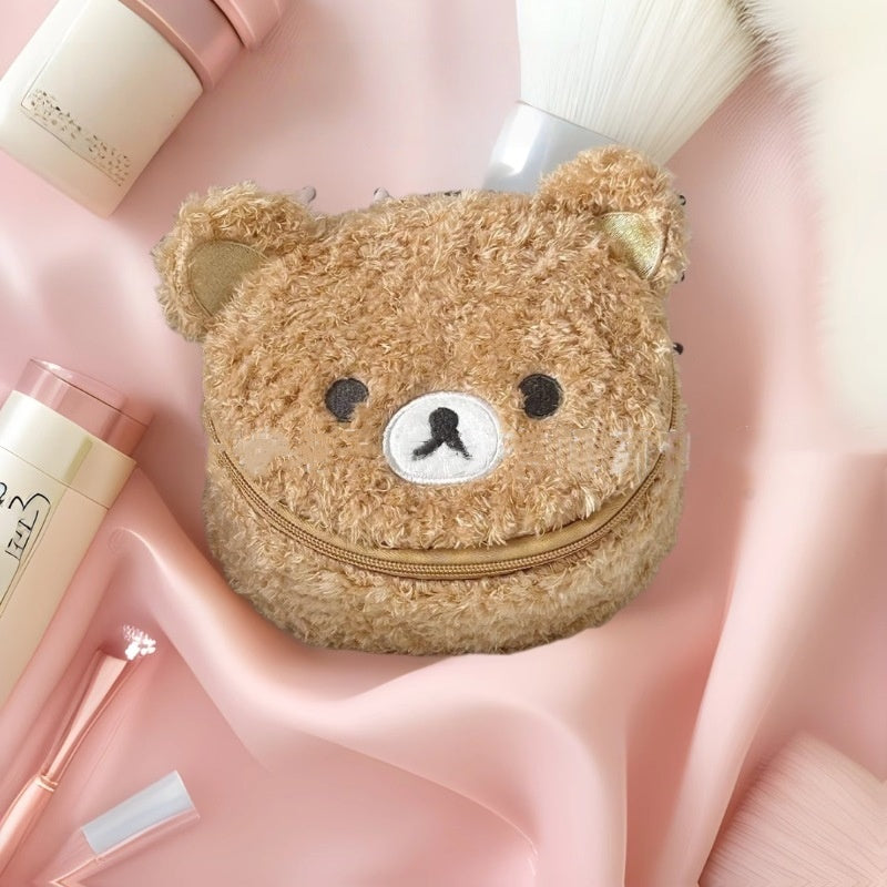 Cute oval lambswool cosmetic pouch with 3D bear head detail, shown from the side to highlight its plush texture and shape