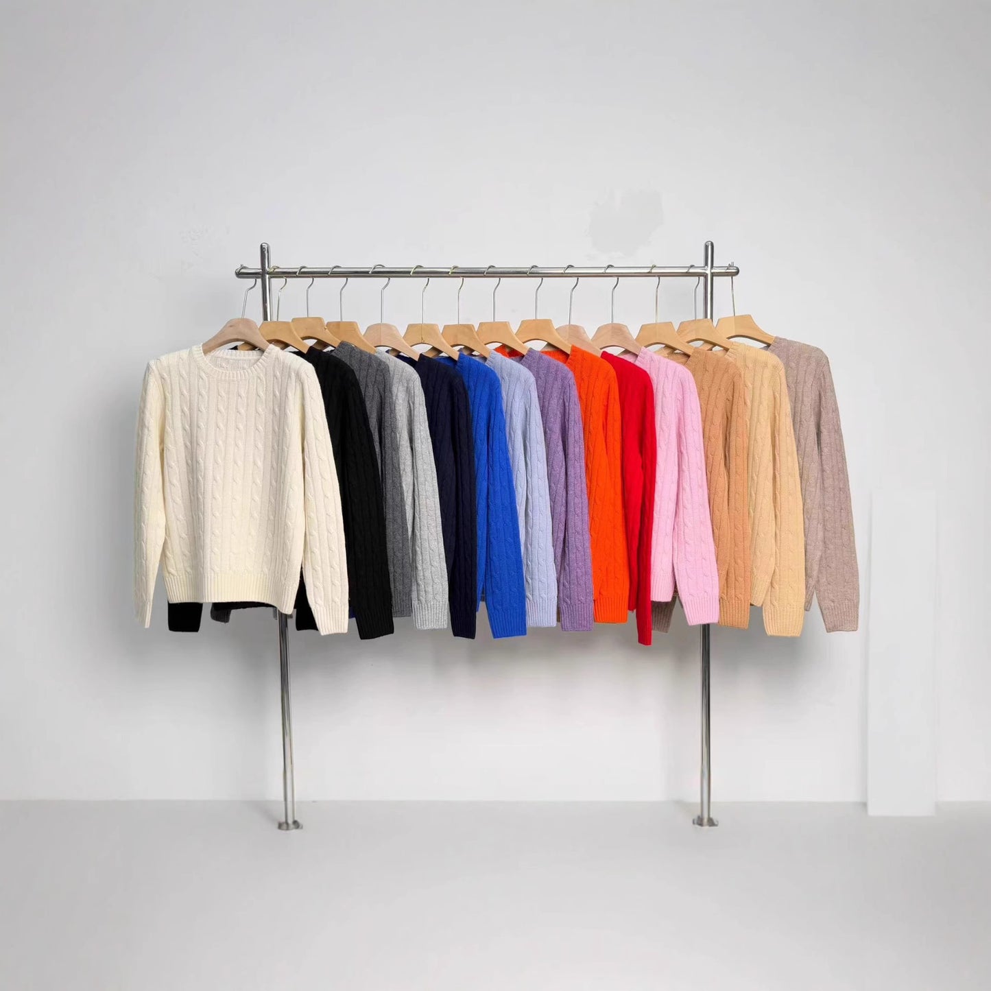 Women's merino wool knit pullover sweater with embroidered detail, shown in a close-up view