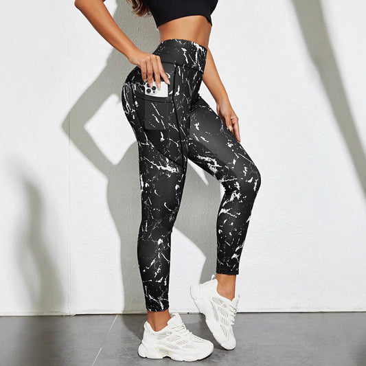 Women's high-waist tummy control leggings in a color block design, flat lay on a white background