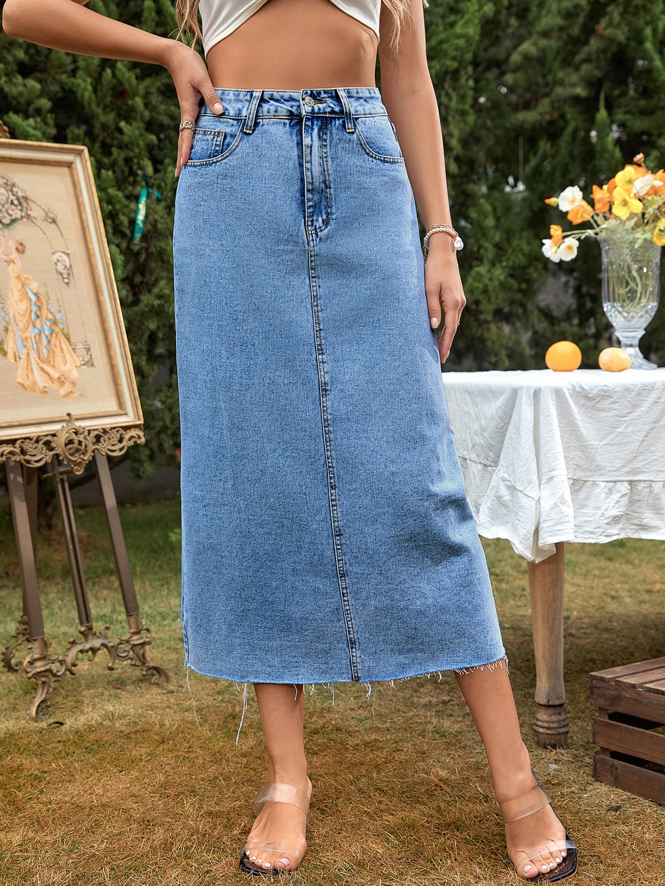 Women's high-waisted A-line denim skirt in dark blue, shown from a side angle highlighting the flared silhouette and waistban