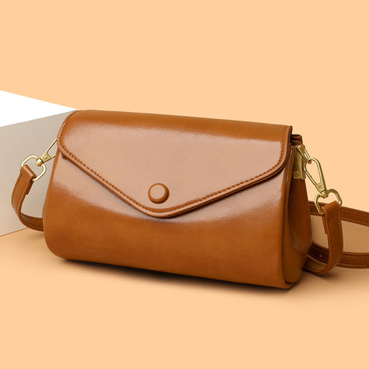 Retro PU leather women's crossbody bag with multiple compartments, shown in a casual urban style