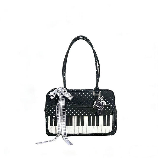 Lightweight black and white polka-dot piano key shoulder bag with structured square silhouette, cotton exterior, and bold graphic print — a stylish everyday casual bag for women.