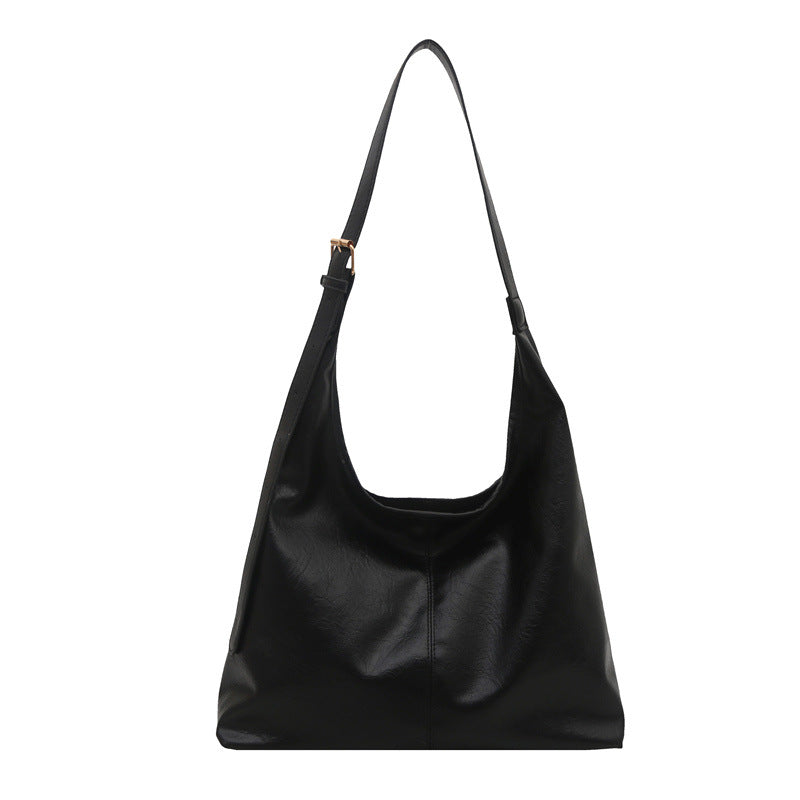 Stylish large-capacity PU shoulder tote bag for women in classic black, shown as a structured winter everyday bag with double straps and minimalist design