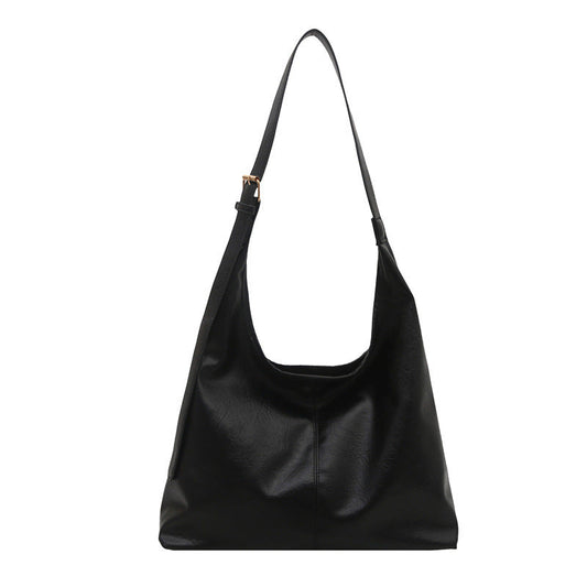 Stylish large-capacity PU shoulder tote bag for women in classic black, shown as a structured winter everyday bag with double straps and minimalist design