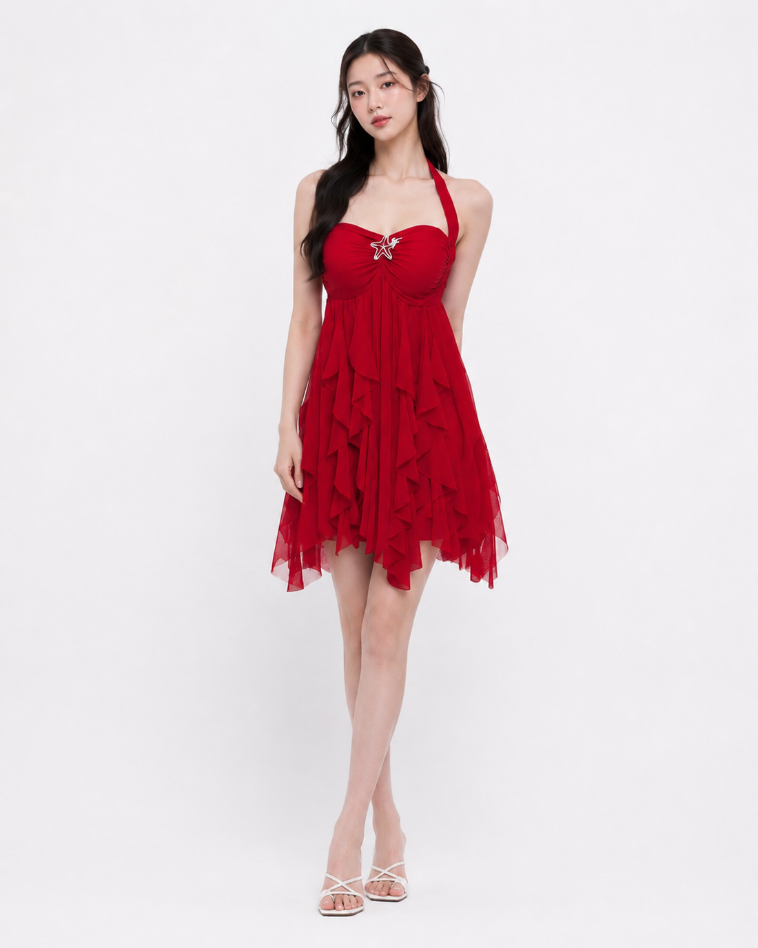 Woman wearing a printed mesh halter mini dress with a backless halter neck design and high-waist cut, styled for a night out or party occasion