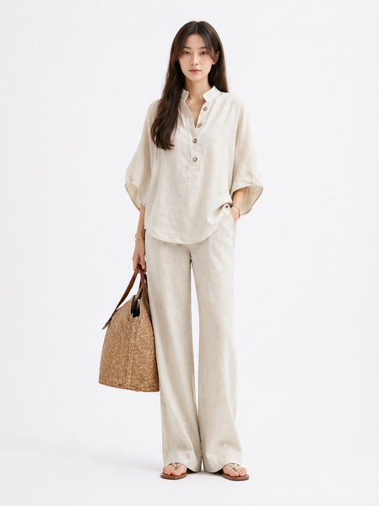 Woman wearing a relaxed short sleeve top and straight-leg trousers two-piece set in a neutral cotton linen blend, styled for a casual polished everyday look