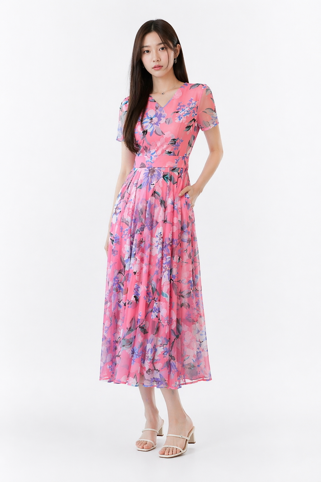 Plus size woman wearing a vibrant floral print V-neck midi dress with short sleeves, styled for a casual summer outing