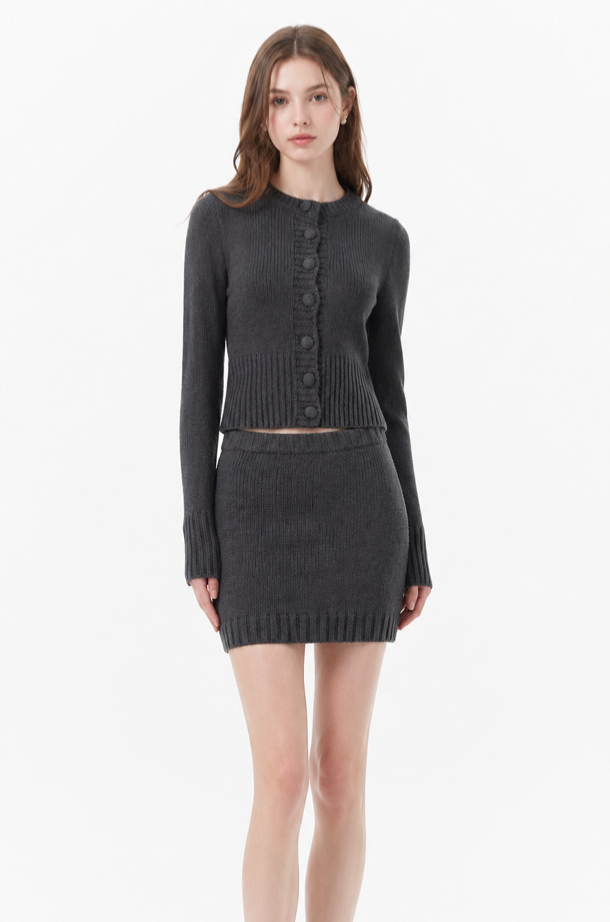 Women wearing a high-waisted knit co-ord set with a long-sleeve button-detail top and fitted sheath skirt in beige, styled for a clean street-style look