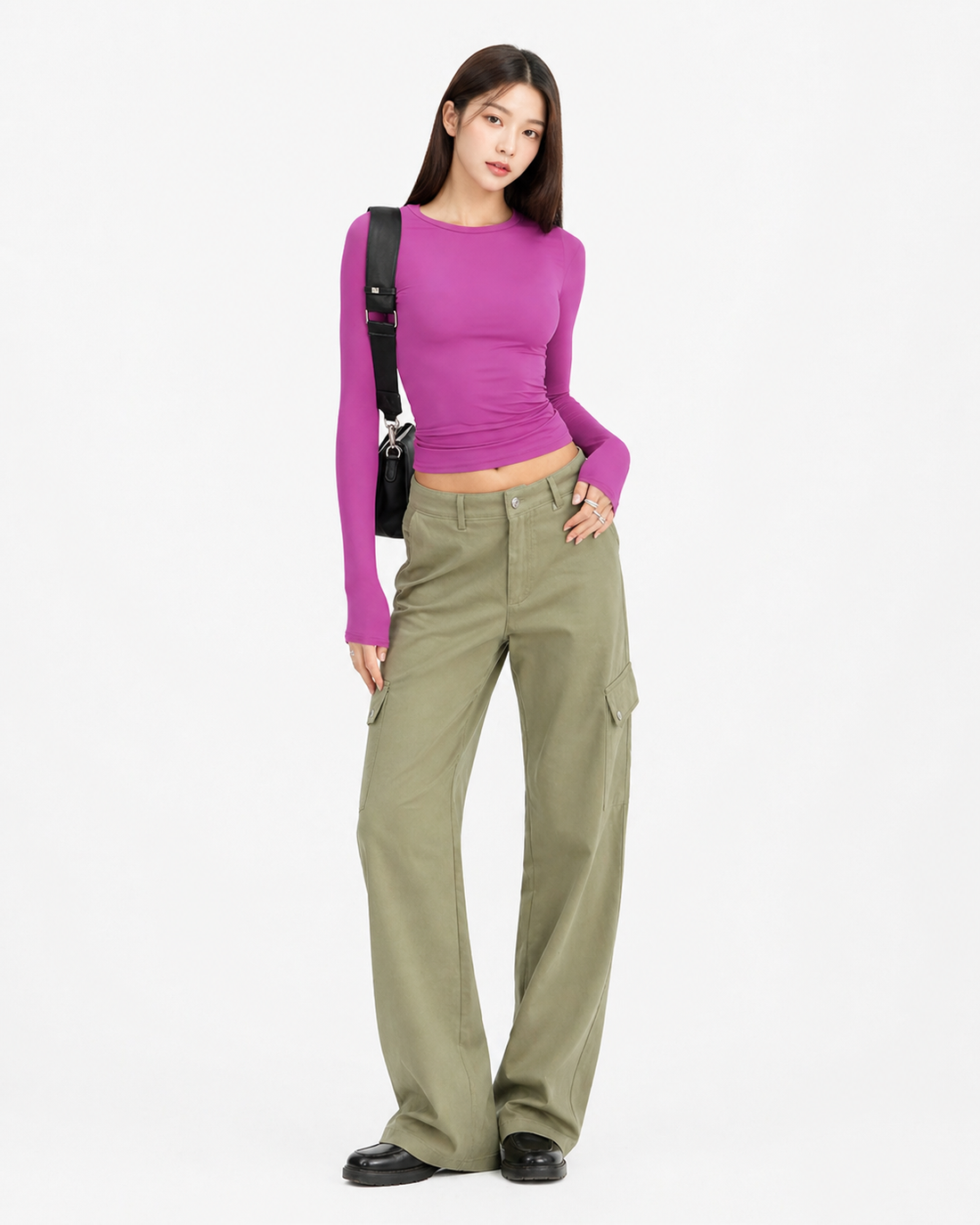 Woman wearing a slim fit solid color long sleeve pullover top in a clean minimalist style, ideal for casual outings and relaxed office days