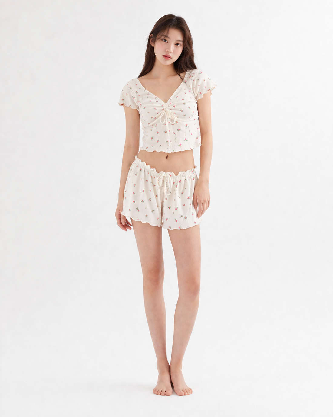 Woman wearing a matching V-neck crop top and shorts two-piece set in a casual summer style, featuring adjustable straps and lightweight fabric perfect for warm weather outings.