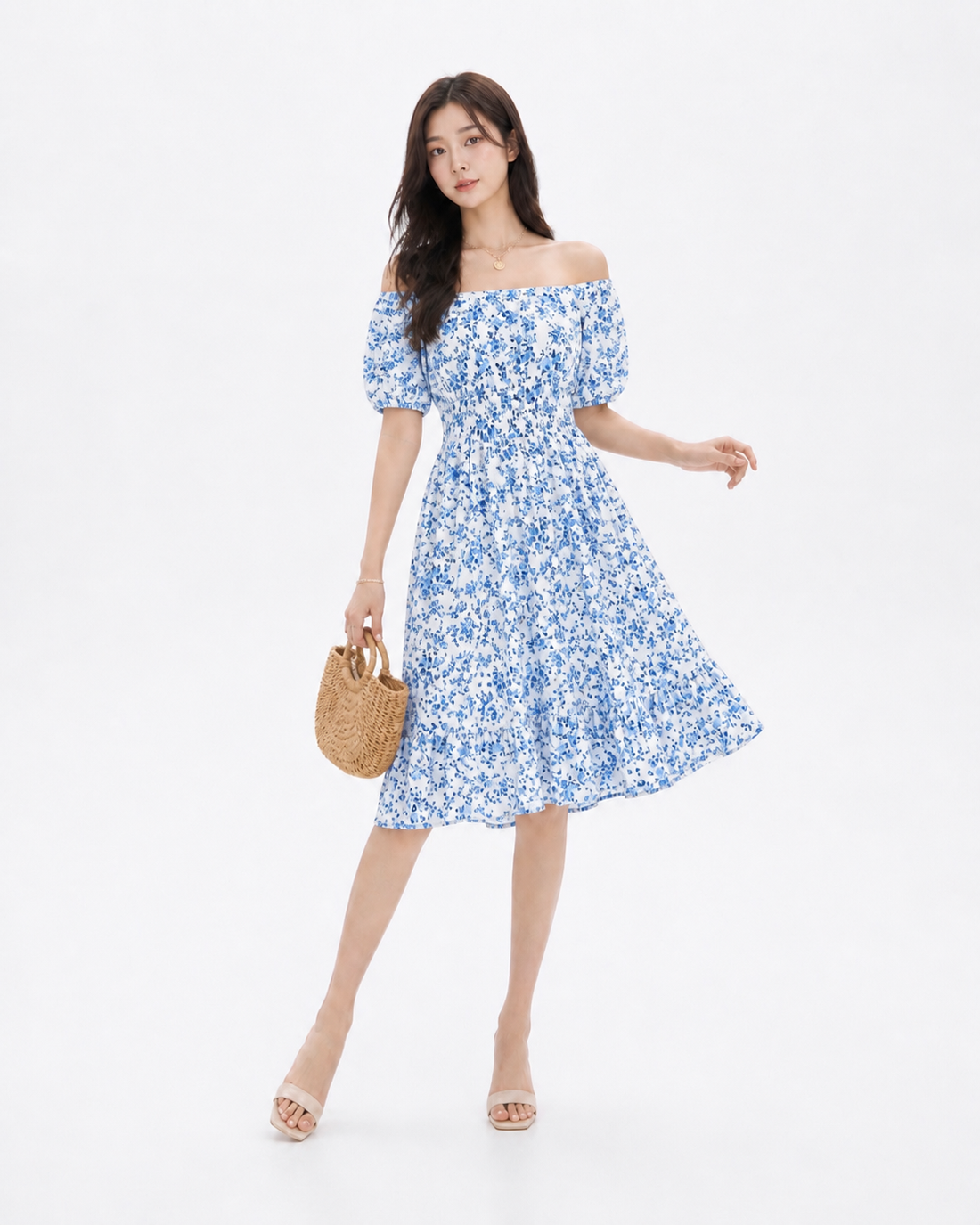 Woman wearing a floral ruffle midi dress with a square neckline and high-waist silhouette in a light summer setting, styled for a casual warm-weather outing