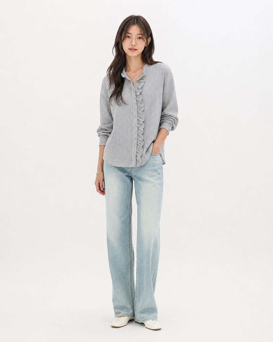 Woman wearing a striped ruffle button-up blouse with long sleeves, styled as a polished office top in white with classic stripe detailing and feminine ruffle front, from Sakurak Beauty.
