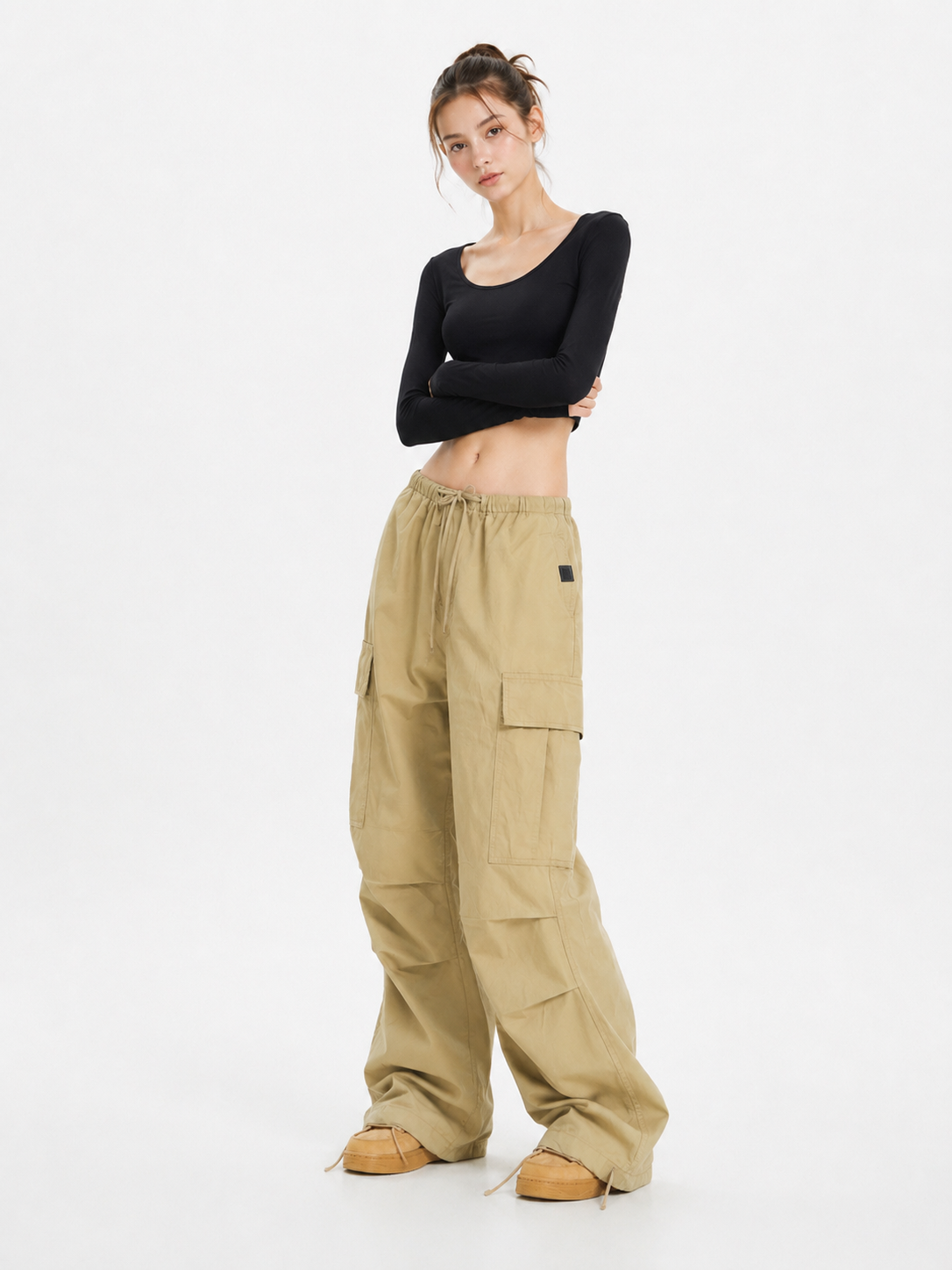 Model wearing retro wide leg cargo pants in khaki with multiple side pockets, styled for a casual streetwear look, available in unisex sizing from XS to 2XL.