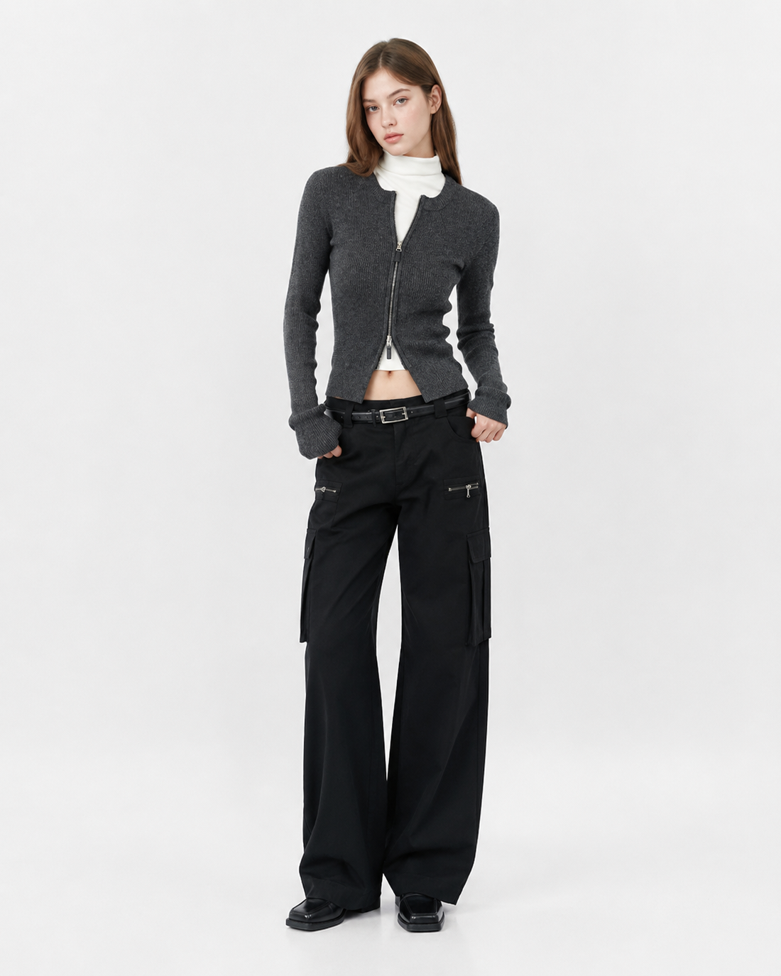 Woman wearing a slim fit ribbed knit sweater top with a double zipper front detail in black, styled for a casual Korean-inspired everyday look