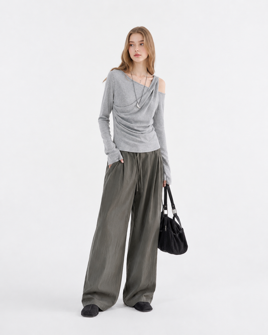 Woman wearing a slim-fit pleated waist-cinch long sleeve top in solid gray, styled in a Korean minimalist aesthetic for a casual yet polished everyday look.
