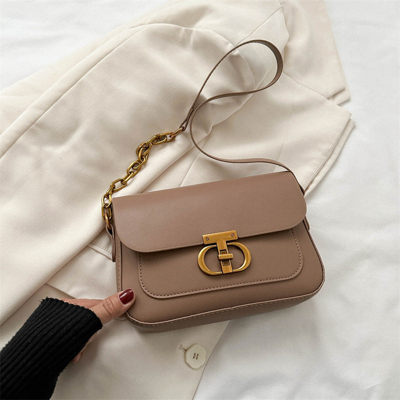 Korean-style women's shoulder bag in soft PU leather, featuring a personalized monogram detail and structured silhouette for 