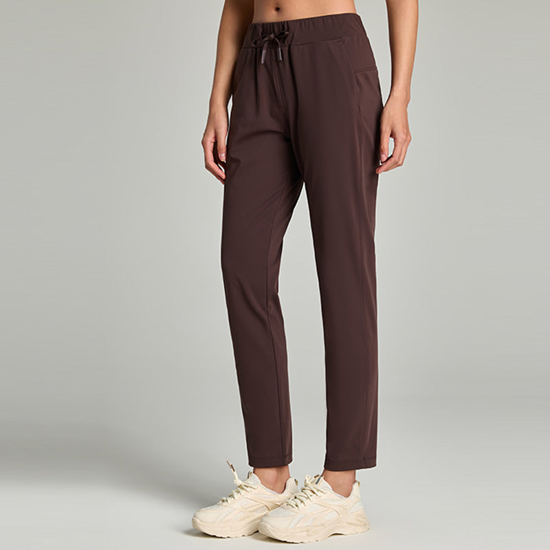 Women's loose straight-leg cropped pants with an elastic drawstring waist, shown in a relaxed casual style