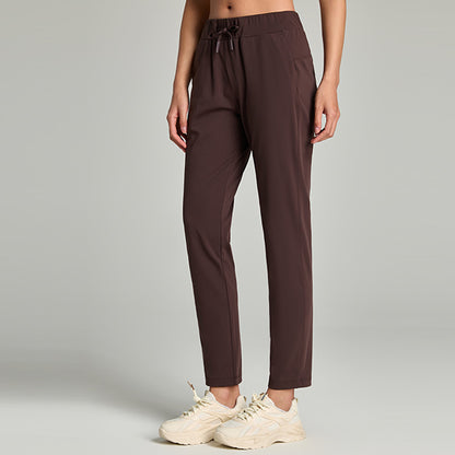 Women's loose straight-leg cropped pants with an elastic drawstring waist, shown in a relaxed casual style