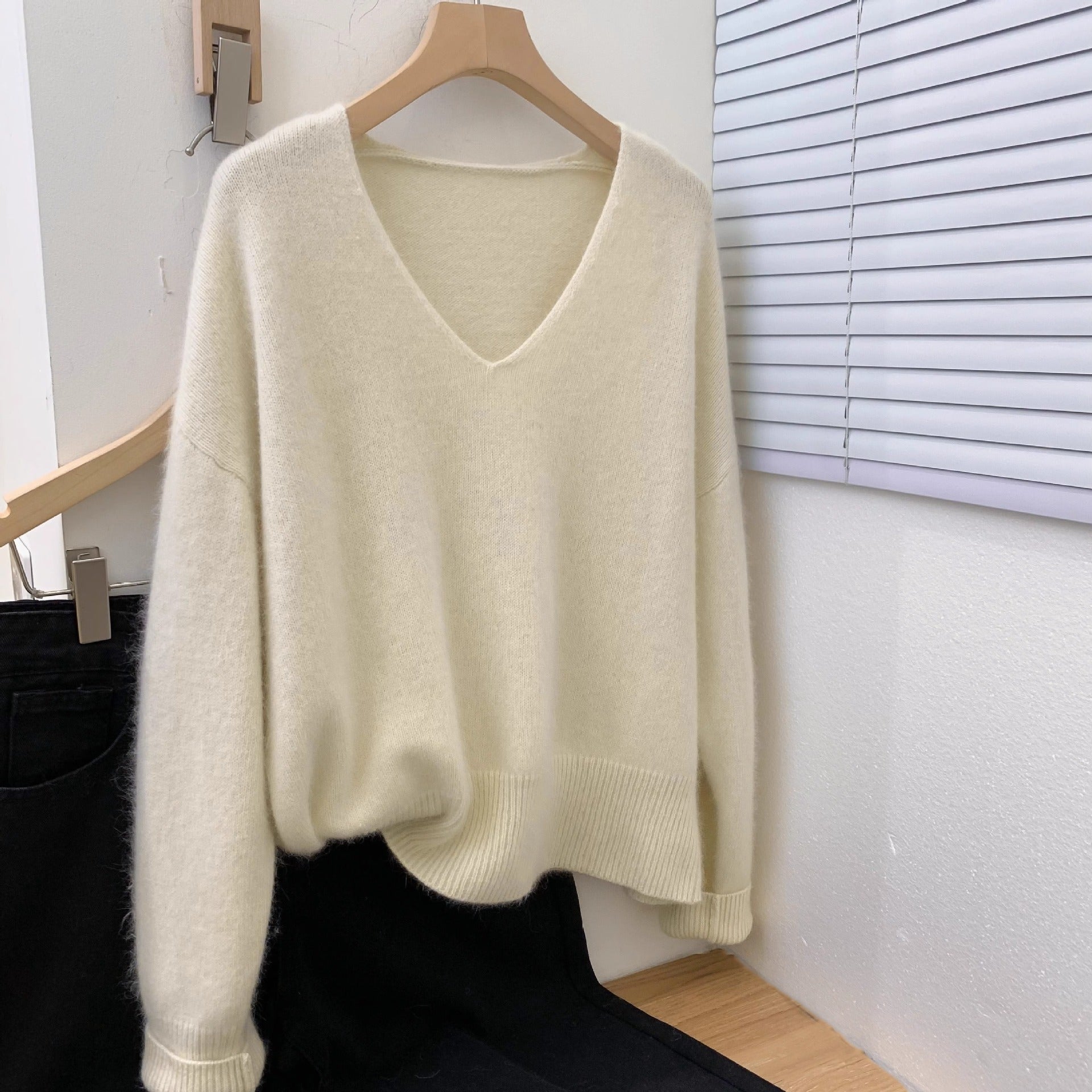 Women's loose fit v-neck pullover sweater with crochet lace trim, long sleeves, draped in a relaxed elegant silhouette