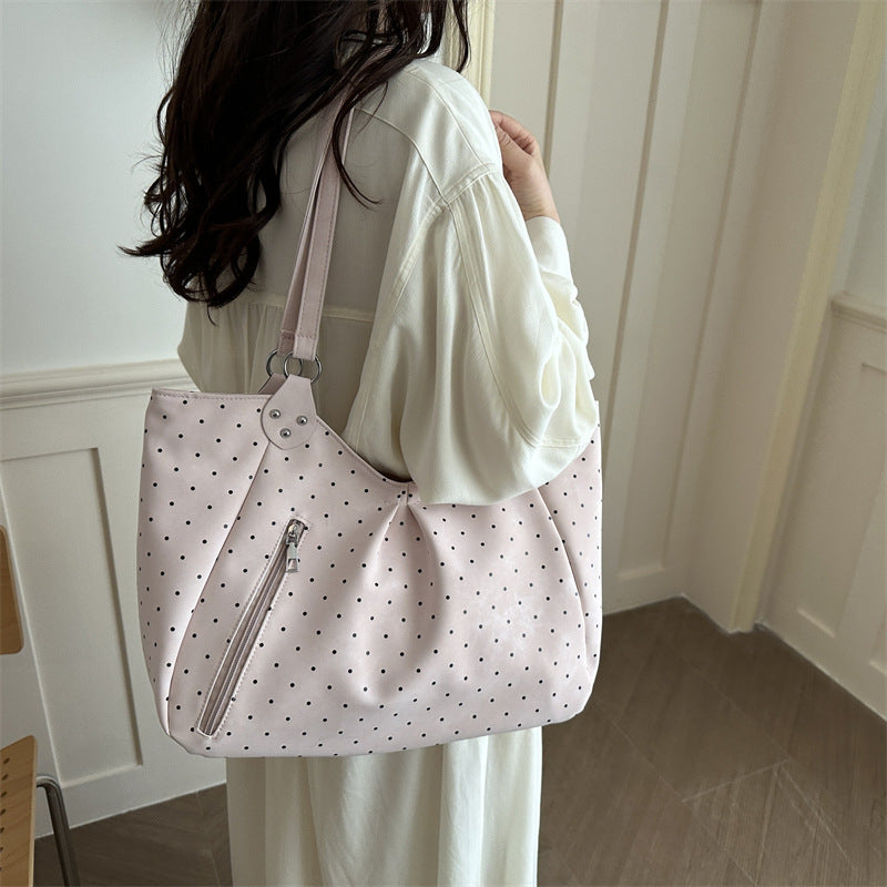 Spacious canvas tote shoulder bag for women shown from the side, highlighting its large capacity and sturdy handles