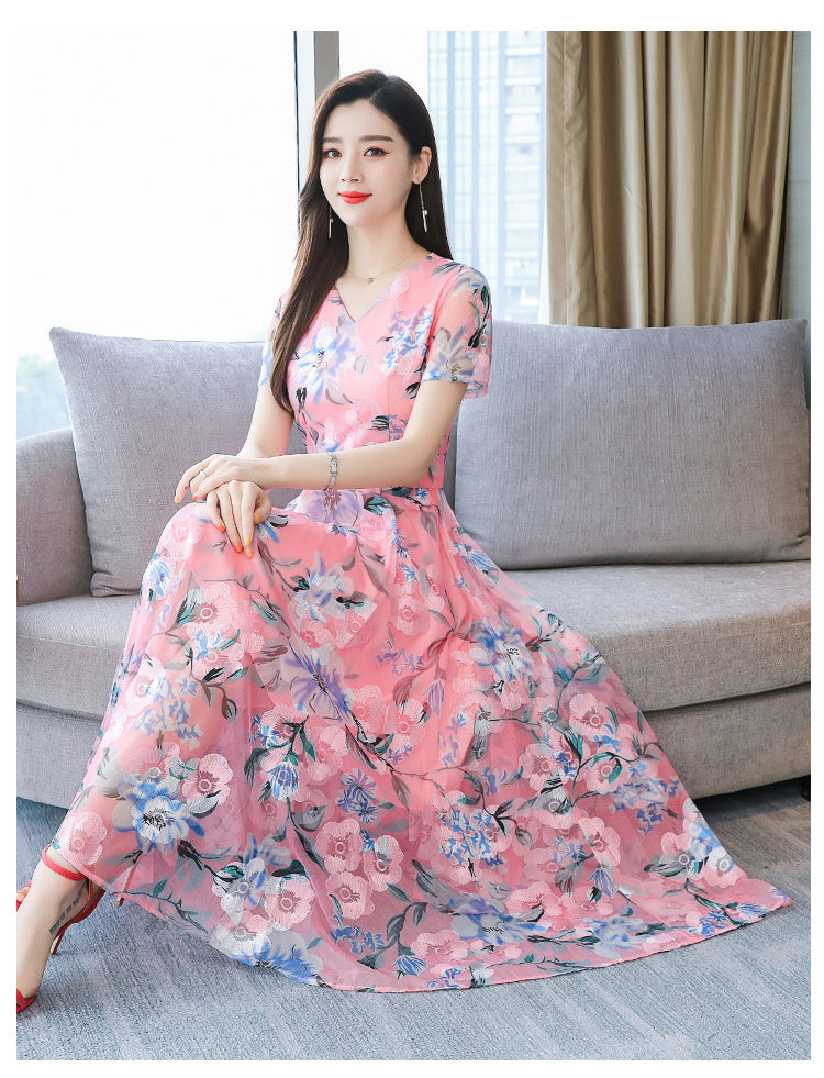 Plus size floral midi dress with V-neck and short sleeves, shown in a colorful summer floral print