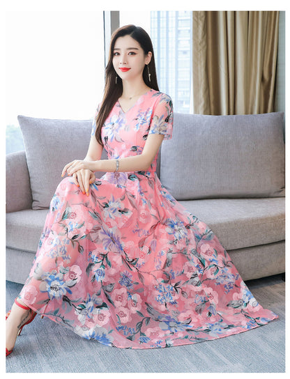 Plus size floral midi dress with V-neck and short sleeves, shown in a colorful summer floral print