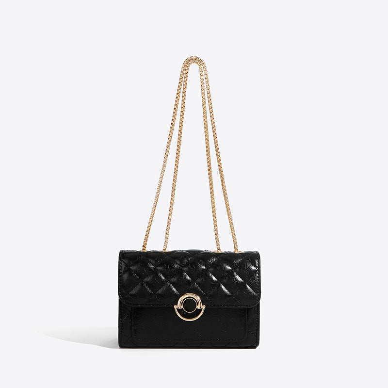 Minimalist PU crossbody bag with gold chain strap, shown in a neutral tone with a structured silhouette