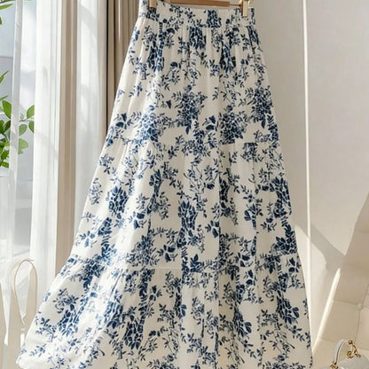 Women's high-waisted floral print midi skirt with a flared A-line silhouette, shown in a vibrant all-over flower pattern.