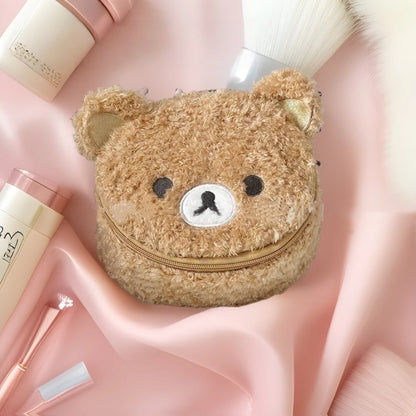 Cute oval lambswool cosmetic pouch with 3D bear head detail, shown from the side to highlight its plush texture and shape