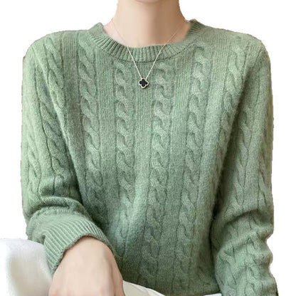 Women's loose cable-knit crewneck sweater in merino wool blend, shown in a relaxed cozy style with textured knit detail