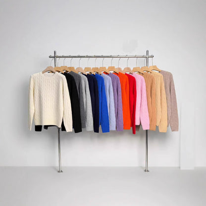 Women's merino wool knit pullover sweater with embroidered detail, shown in a close-up view