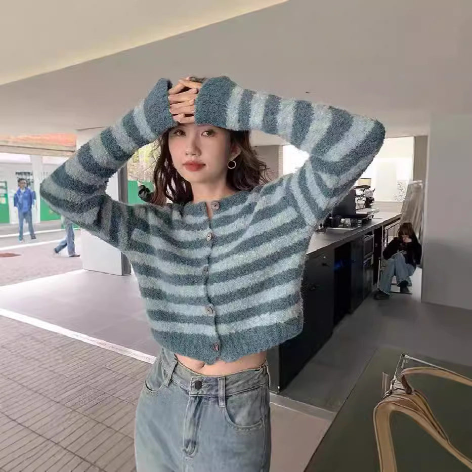 Women's chunky knit short cardigan sweater shown from the back, highlighting the textured open weave and cropped silhouette.
