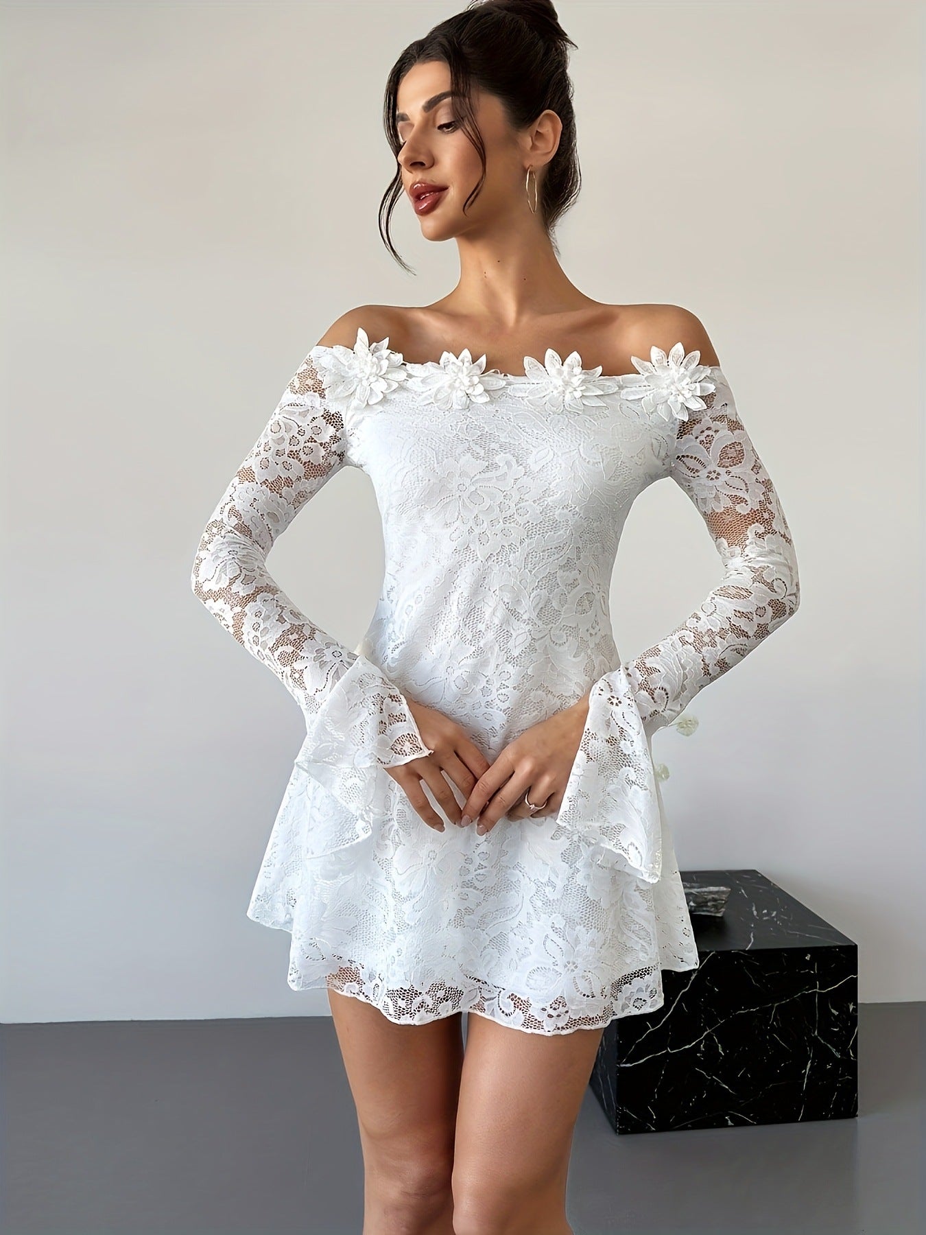 Women's white off-shoulder lace mini dress with bodycon fit, shown from the side to highlight the fitted silhouette and lace 