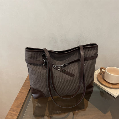 Retro patchwork tote bag with bucket silhouette, shown from the side to highlight colorful fabric panels and structured shape