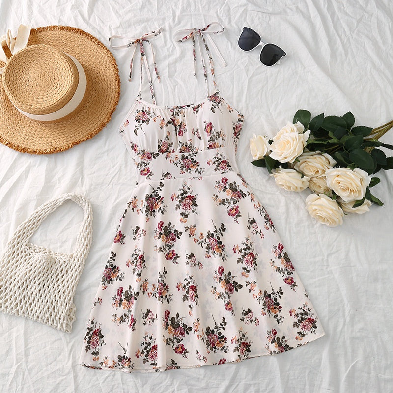 Woman wearing a floral print A-line midi dress with a relaxed summer fit, shown from the side