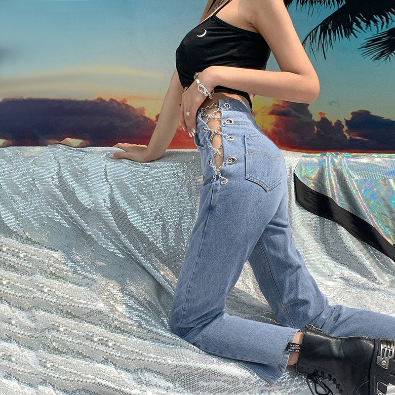 Women's high waist straight leg jeans with decorative chain detail, shown from a close-up angle highlighting the waistband an