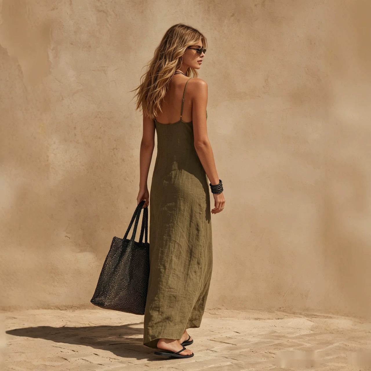 Loose sleeveless slip dress in minimalist resort style, back view showing relaxed maxi silhouette and clean lines