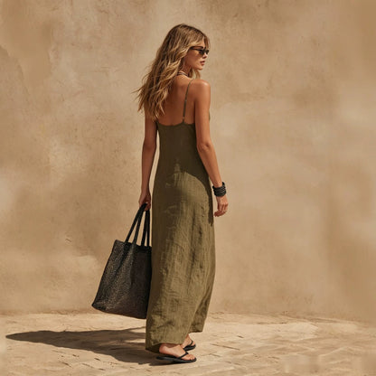 Loose sleeveless slip dress in minimalist resort style, back view showing relaxed maxi silhouette and clean lines