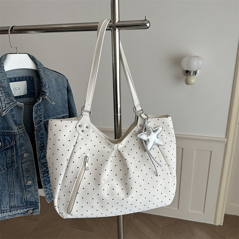 Spacious canvas tote shoulder bag for women shown from the side, highlighting its large capacity and sturdy handles.