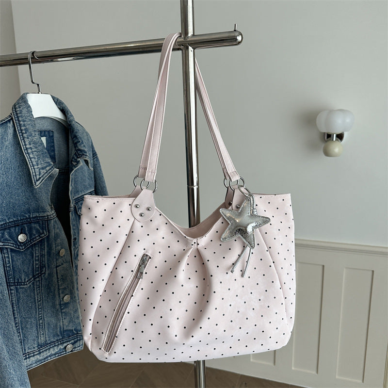 Spacious canvas tote shoulder bag for women shown from the side, highlighting its large capacity and sturdy handles.