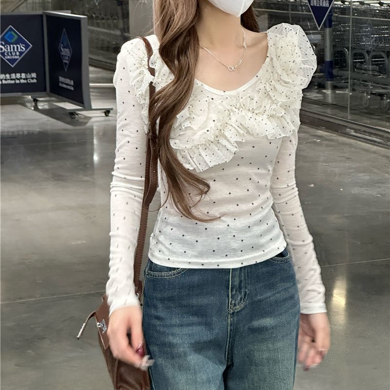 Women's slim-fit long sleeve blouse with polka dot lace detailing, shown in a close-up style view
