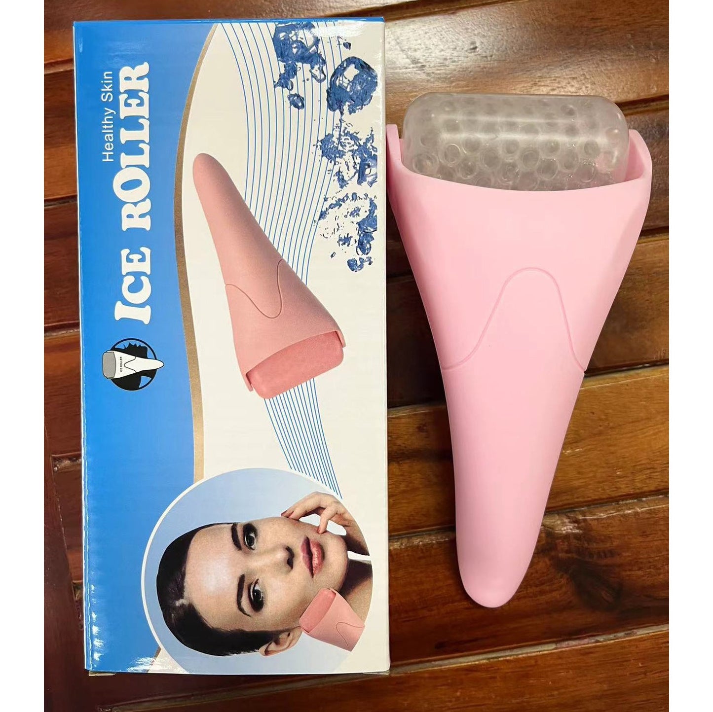 Ice roller massager for face resting on a white surface, showing the cooling facial massage tool's handle and rolling head