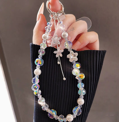 Crystal beaded phone lanyard bracelet with card holder displaying colorful beads, tassel charm, and wrist strap in a flat lay