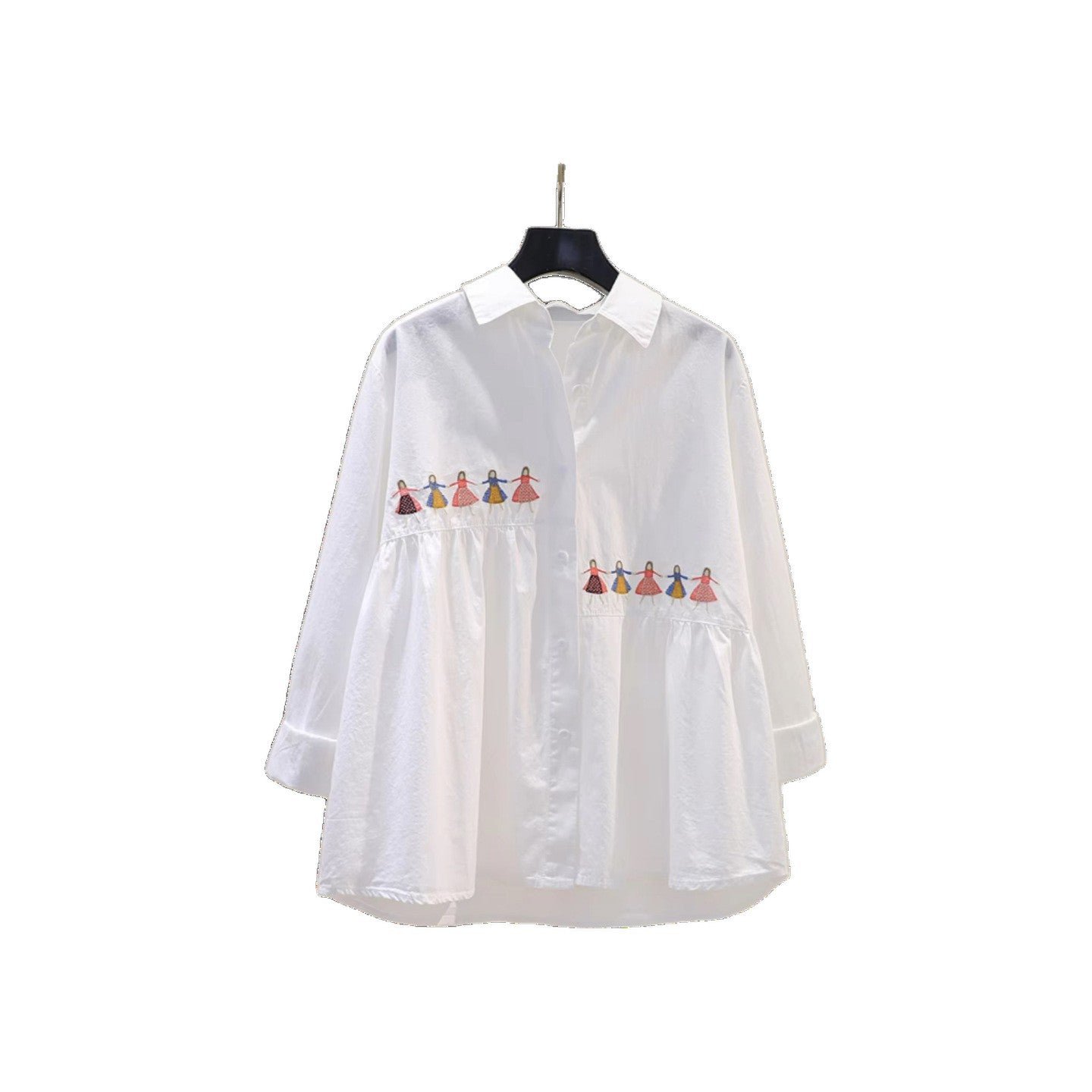 White loose fit cotton blouse with embroidered cartoon detail, shown from a close-up angle highlighting the embroidery design