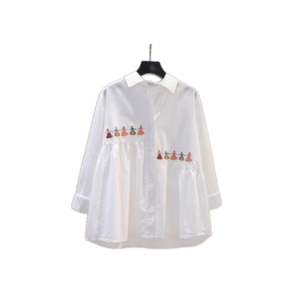 White loose fit cotton blouse with embroidered cartoon detail, shown from a close-up angle highlighting the embroidery design