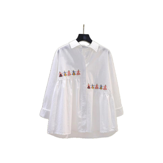 White loose fit cotton blouse with embroidered cartoon detail, shown from a close-up angle highlighting the embroidery design
