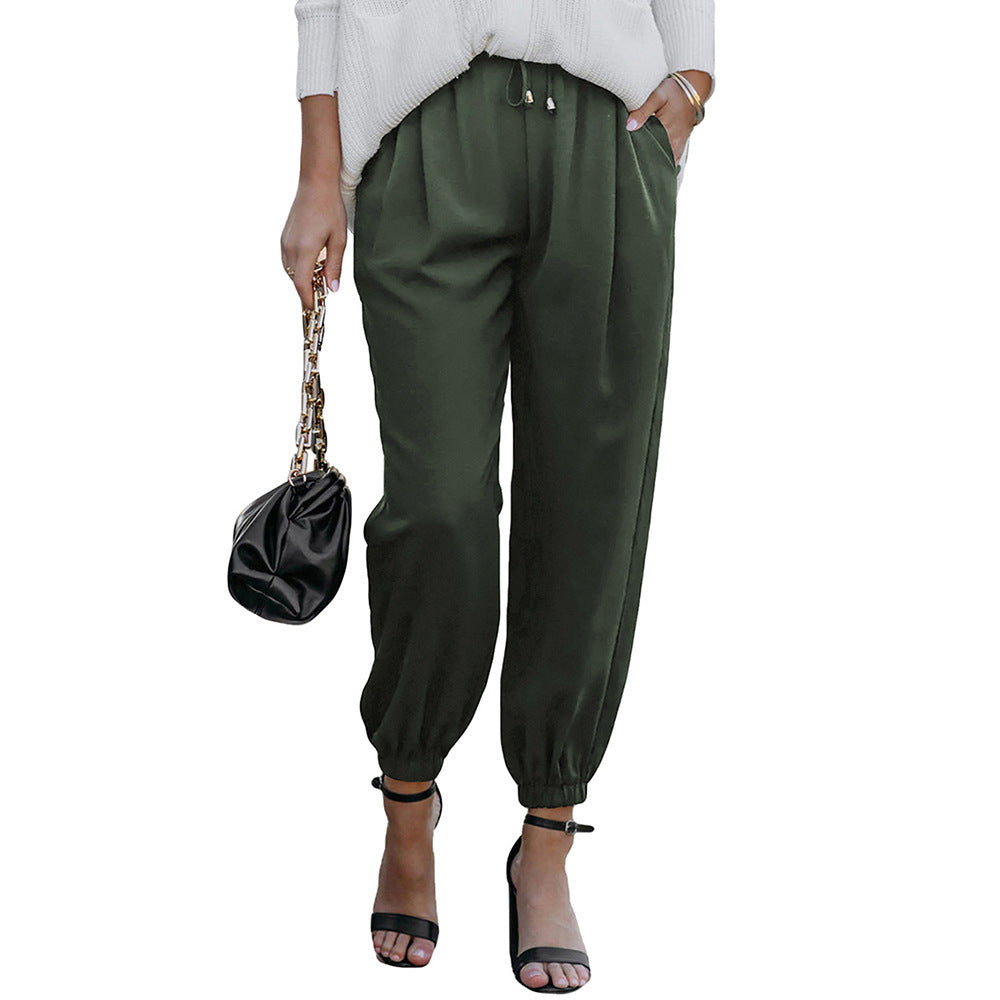 Women's high waist flared trousers with side pockets shown from a side angle, highlighting the wide-leg silhouette and waistb