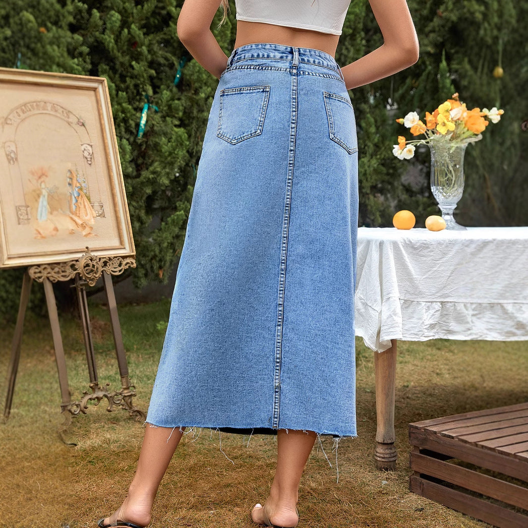 Women's high-waisted A-line denim skirt in dark blue, shown from the side to highlight the flared silhouette and waistband fi
