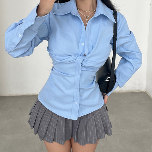 Women's long sleeve button-up shirt with waist detail, shown in a flattering fitted silhouette for a polished everyday look.